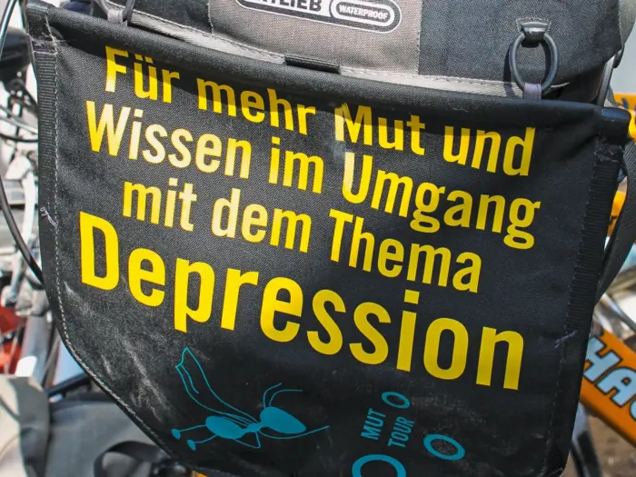 Aufschrift: Für mehr Mut und Wissen im Umgang mit dem Thema Depression